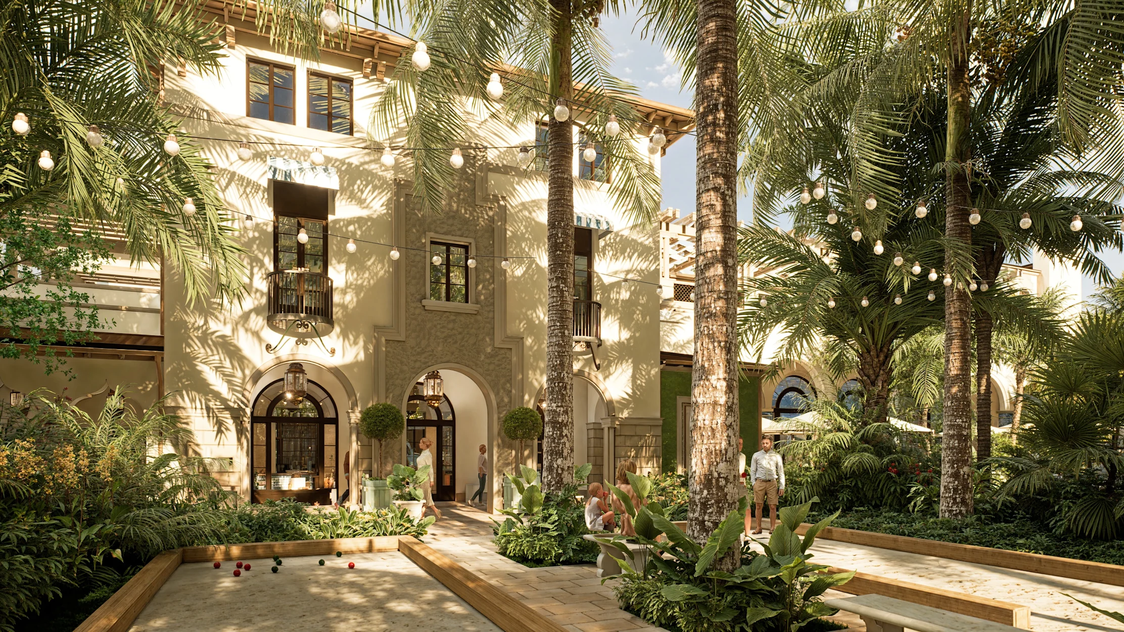 Tropical courtyard with white Spanish-style building, palm trees, string lights, and people relaxing.