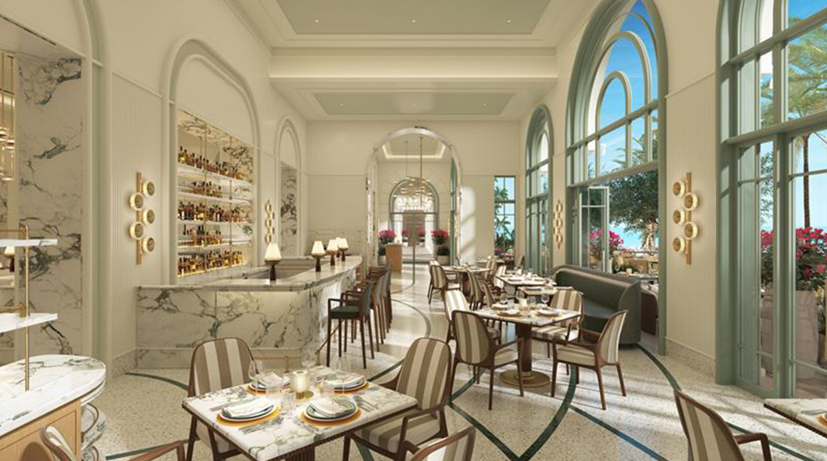 Elegant restaurant interior with arched windows, marble bar, set dining tables, and natural light.