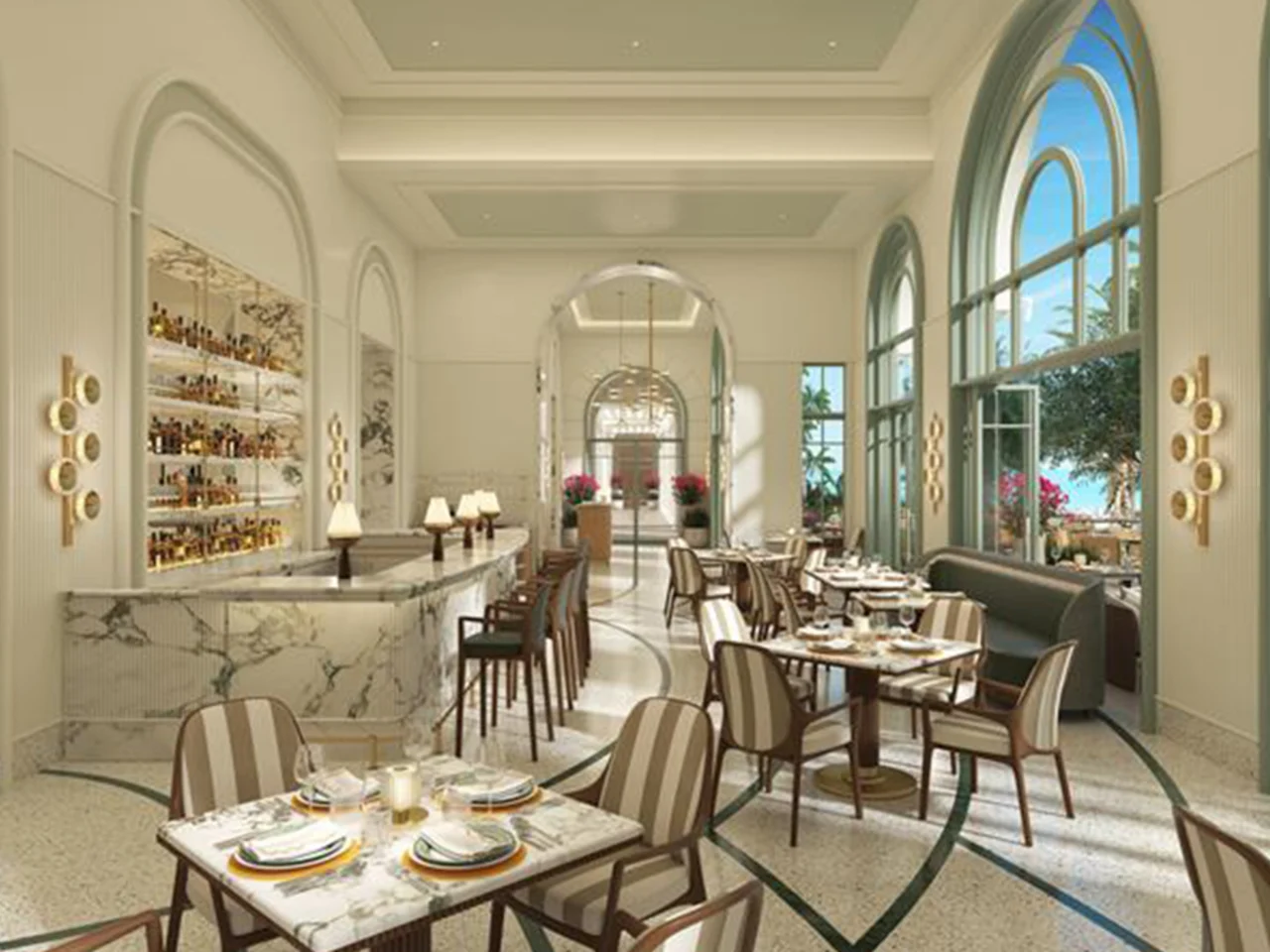 Elegant restaurant interior with arched windows, marble bar, set dining tables, and natural light.