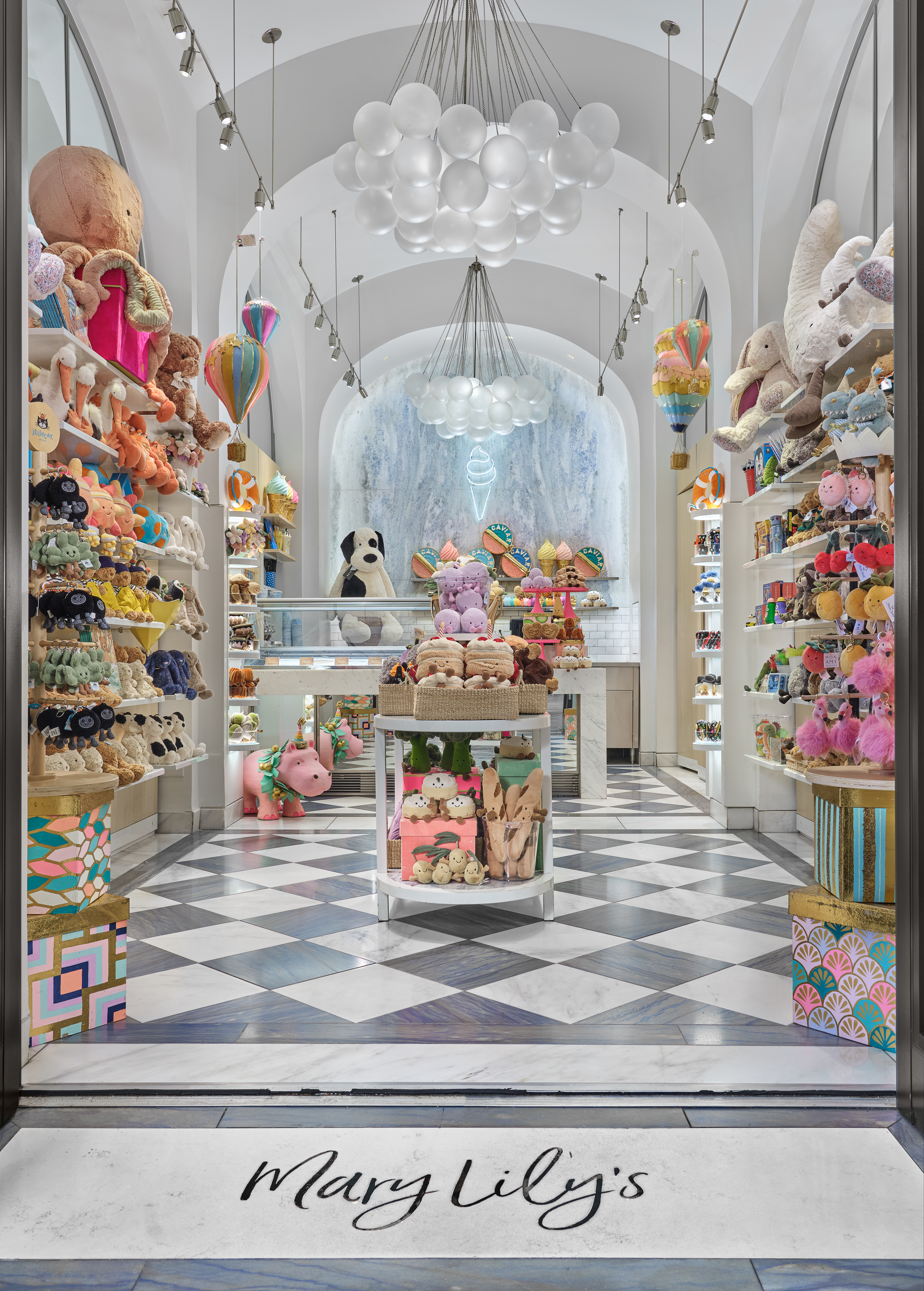 Whimsical toy store interior with white arched ceilings, cloud chandeliers, colorful plush toys on shelves, and checkered floor.
