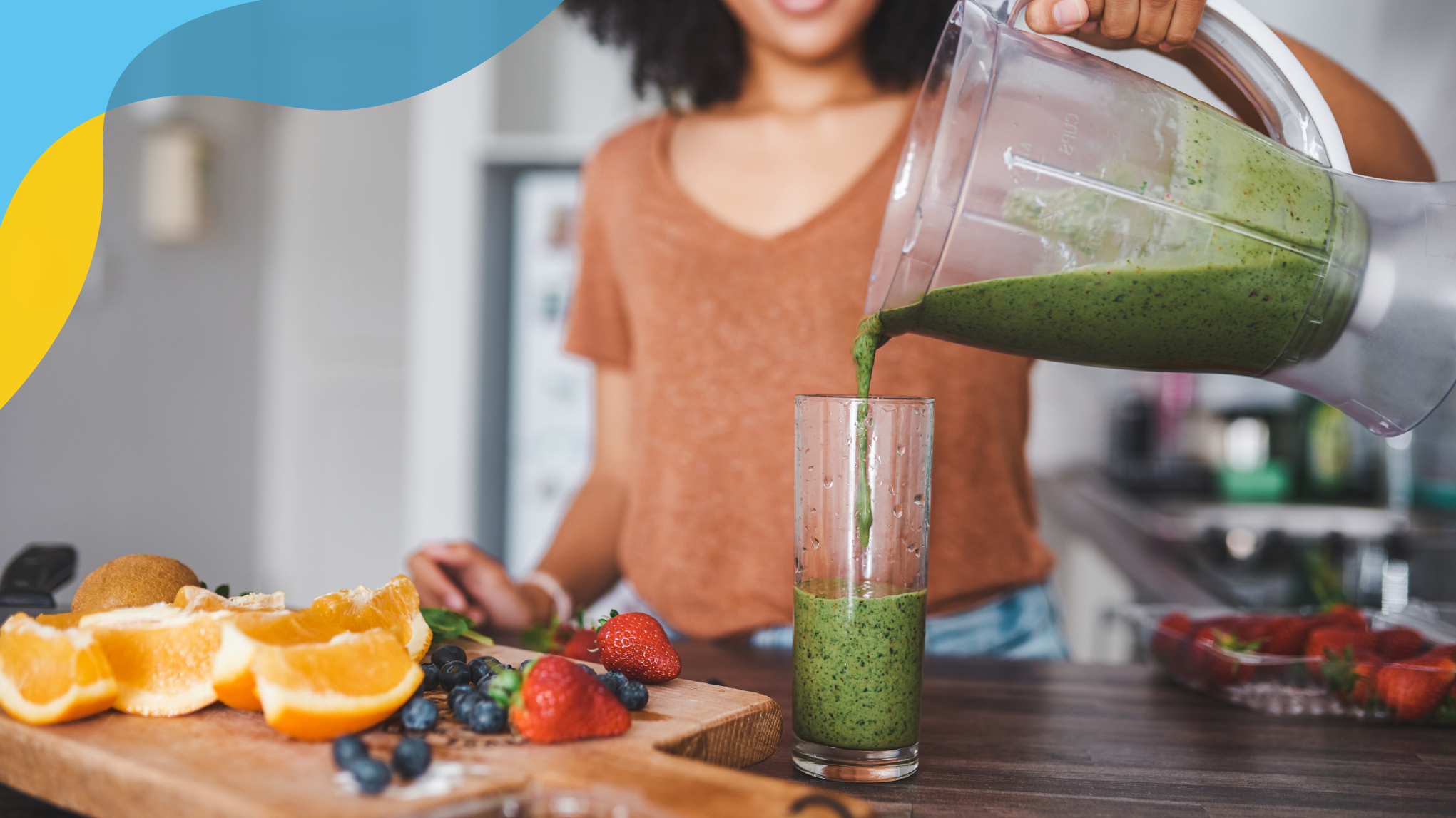 A woman preparing a fruit smoothie and pouring a green smoothie.