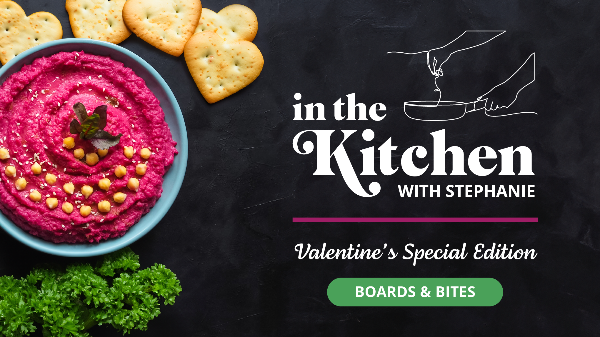 Slate background with a rosy hummus and heart-shaped crackers.