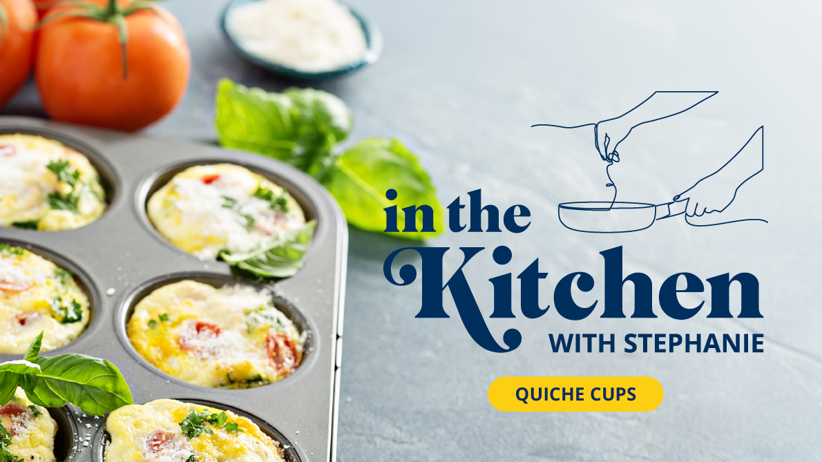 Veggie quiche cups in a muffin tin on a slate background