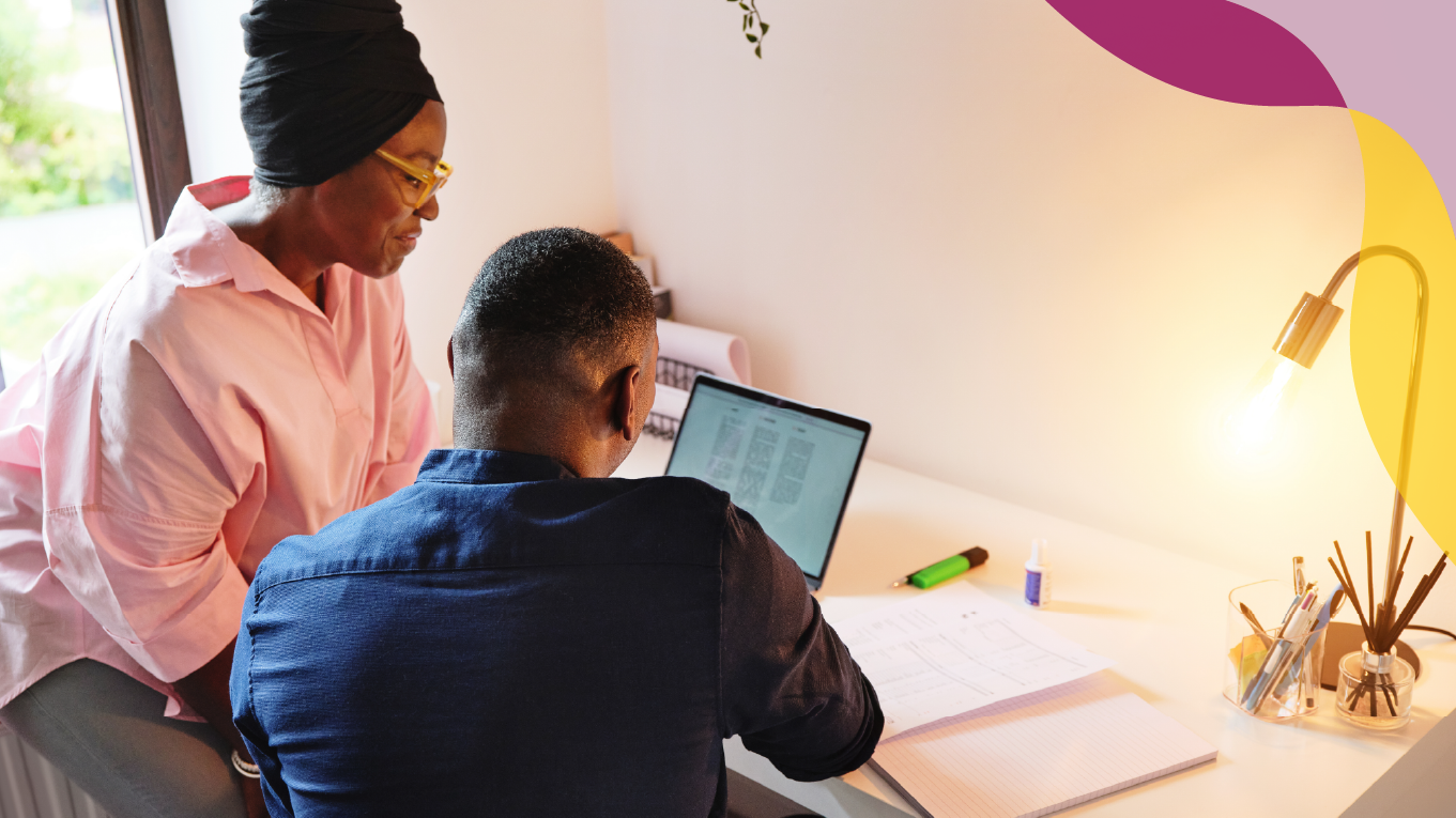 Woman and man reviewing documents on a laptop.