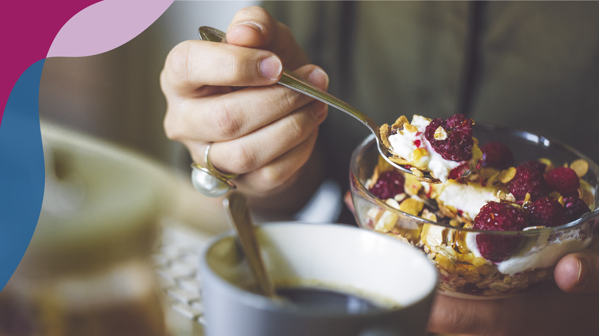 Woman in olive green holding a bowl of oatmeal with raspberries.