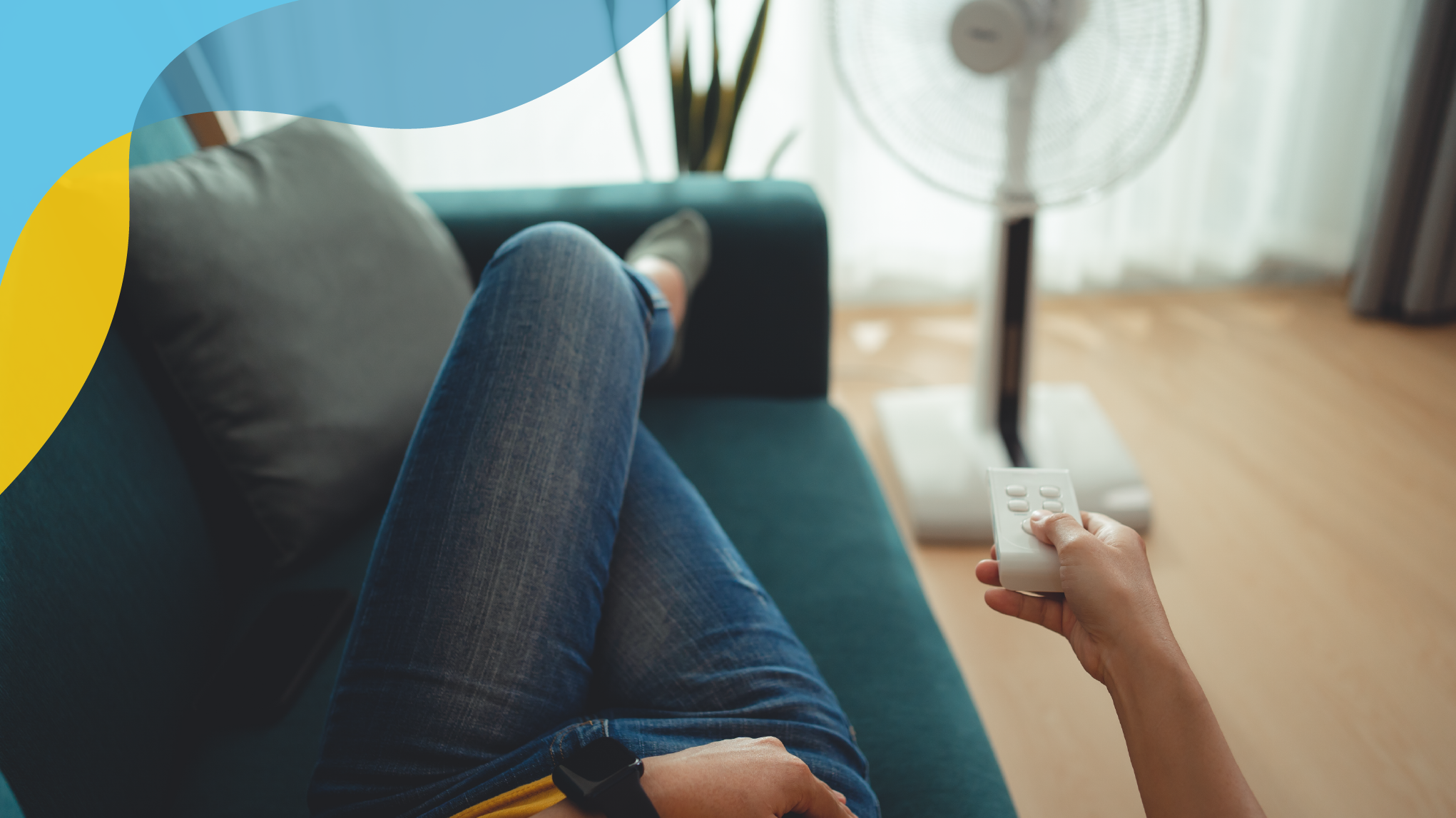 Woman on a couch, turning on a fan to blow directly onto her.