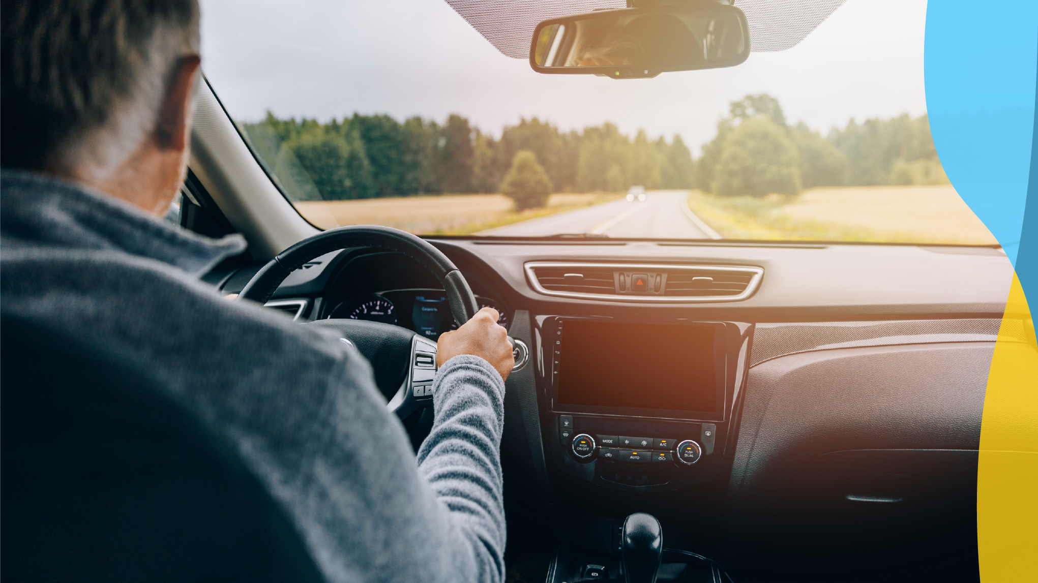 Mature adult male driving a car.