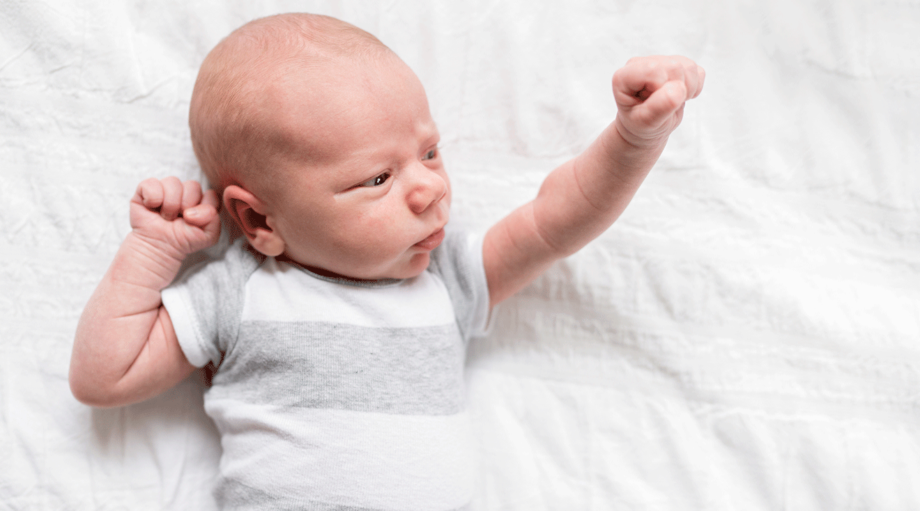 baby clenching fists