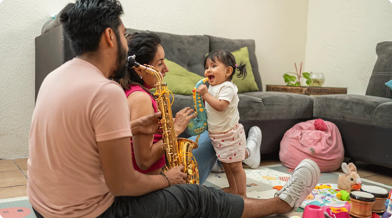 parents play toy instruments with toddler at home