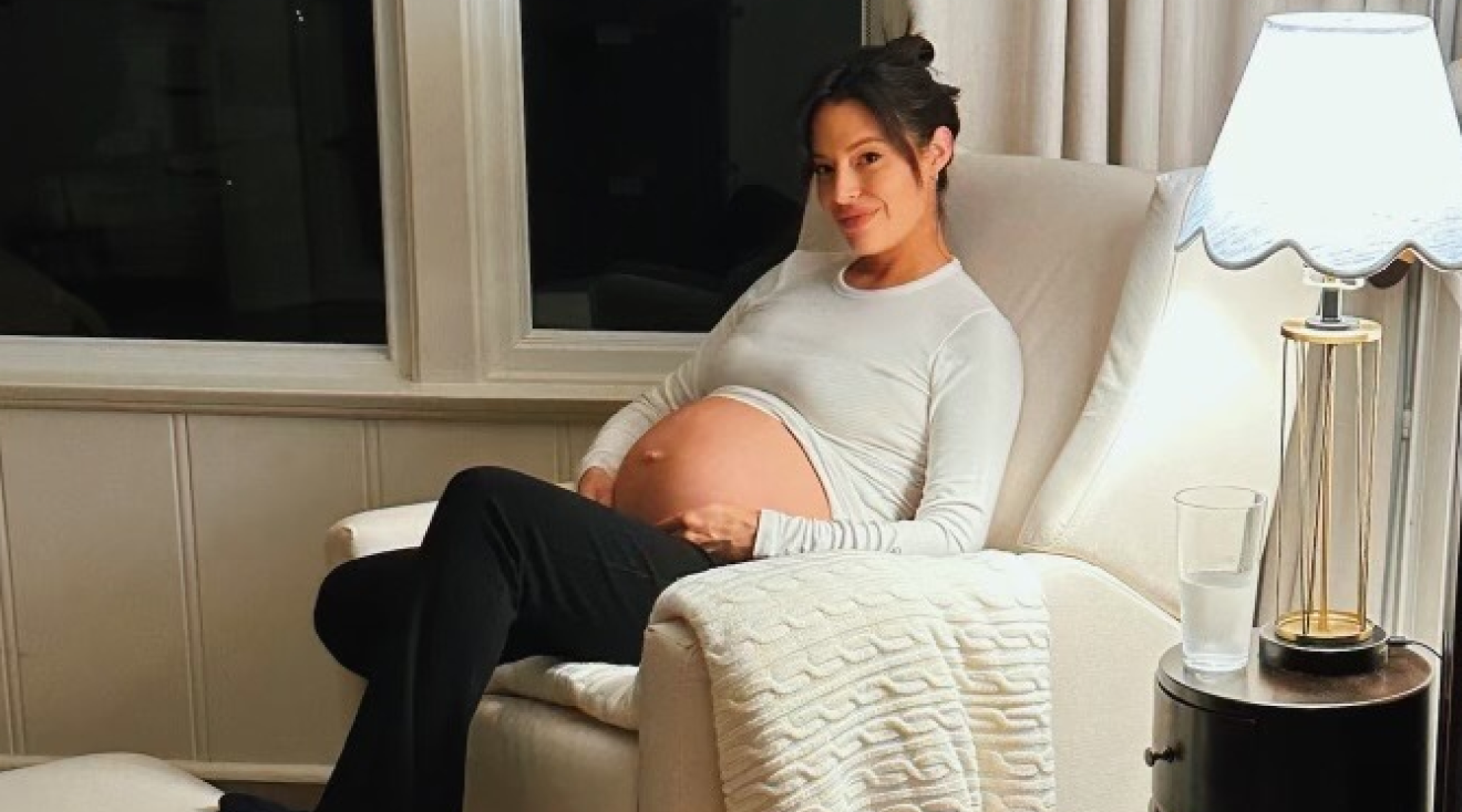 Actress Chloe Bridges sitting in nursery while pregnant