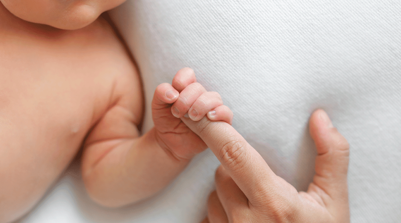 baby grasping mom's finger, palmar grasp