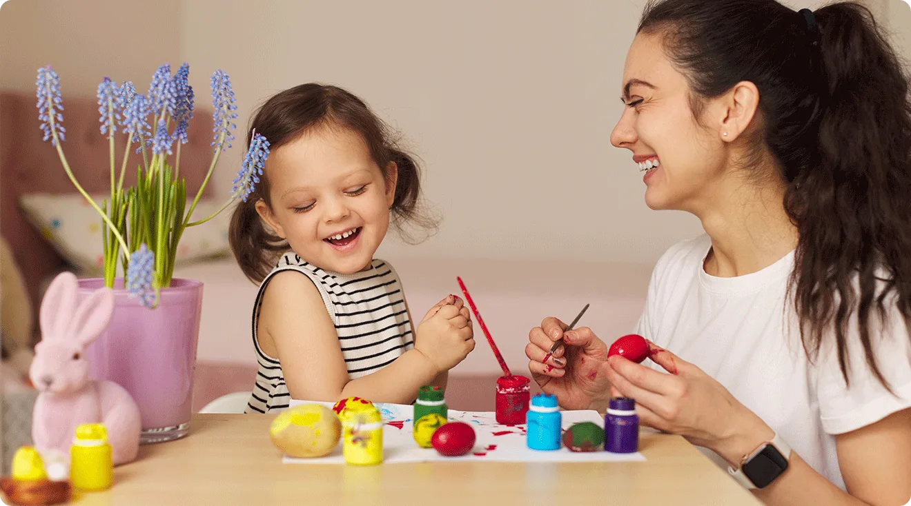 happy mom and toddler doing easter crafts