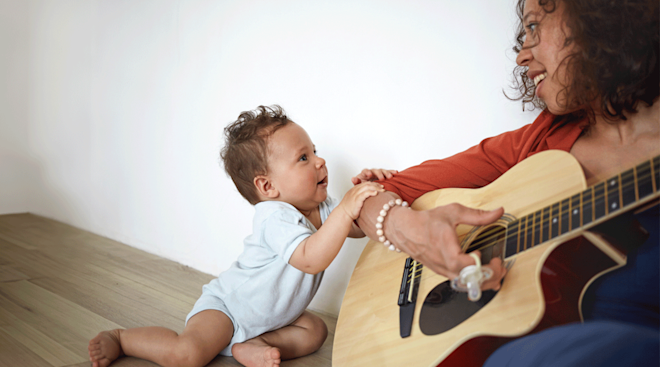 mom singing to baby with guitar
