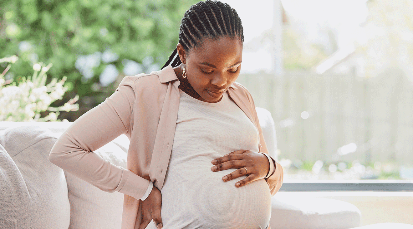 pregnant woman sitting on couch at home