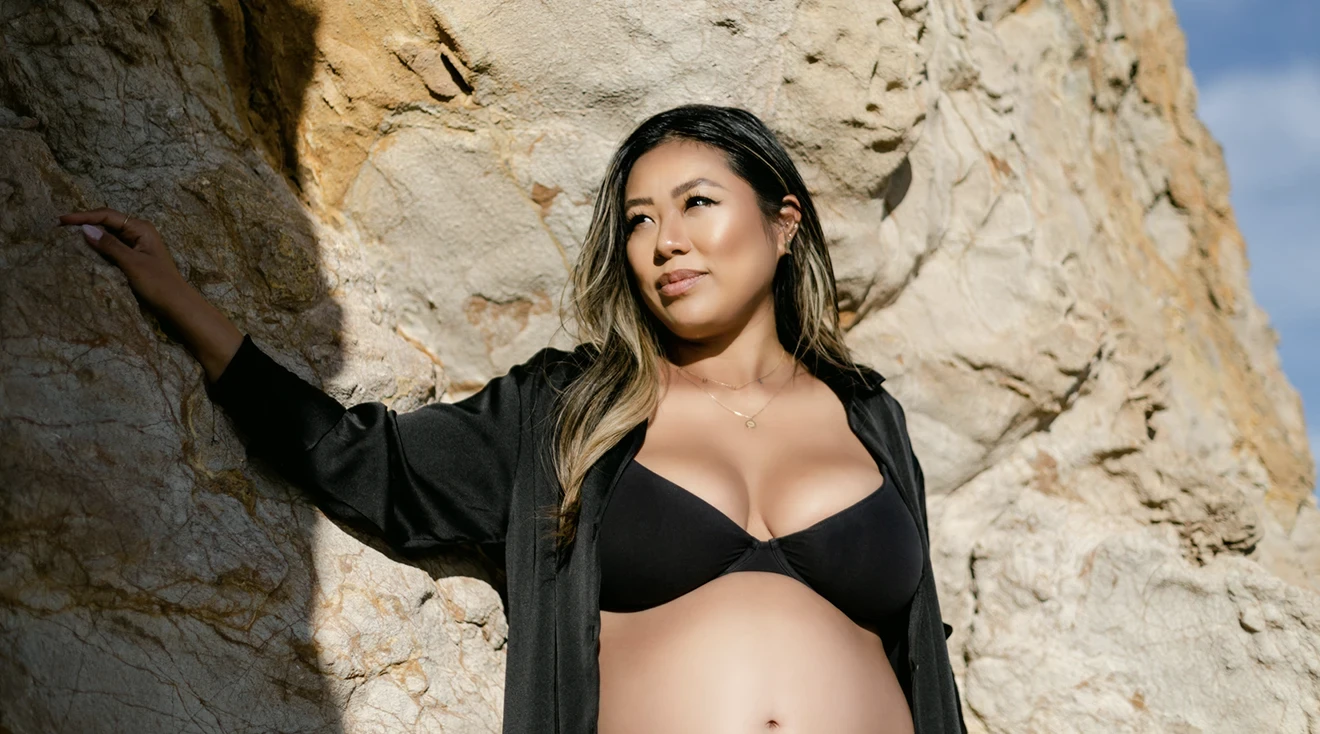 pregnant woman wearing a bikini on the beach