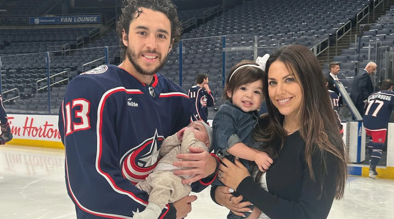 Meredith Gaudreau and John Gaudreau posing with their children on the ice hockey rink