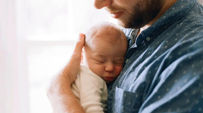 father holding baby