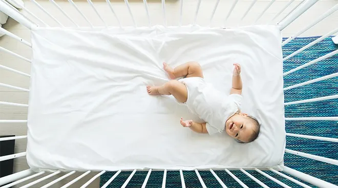 baby in crib smiling