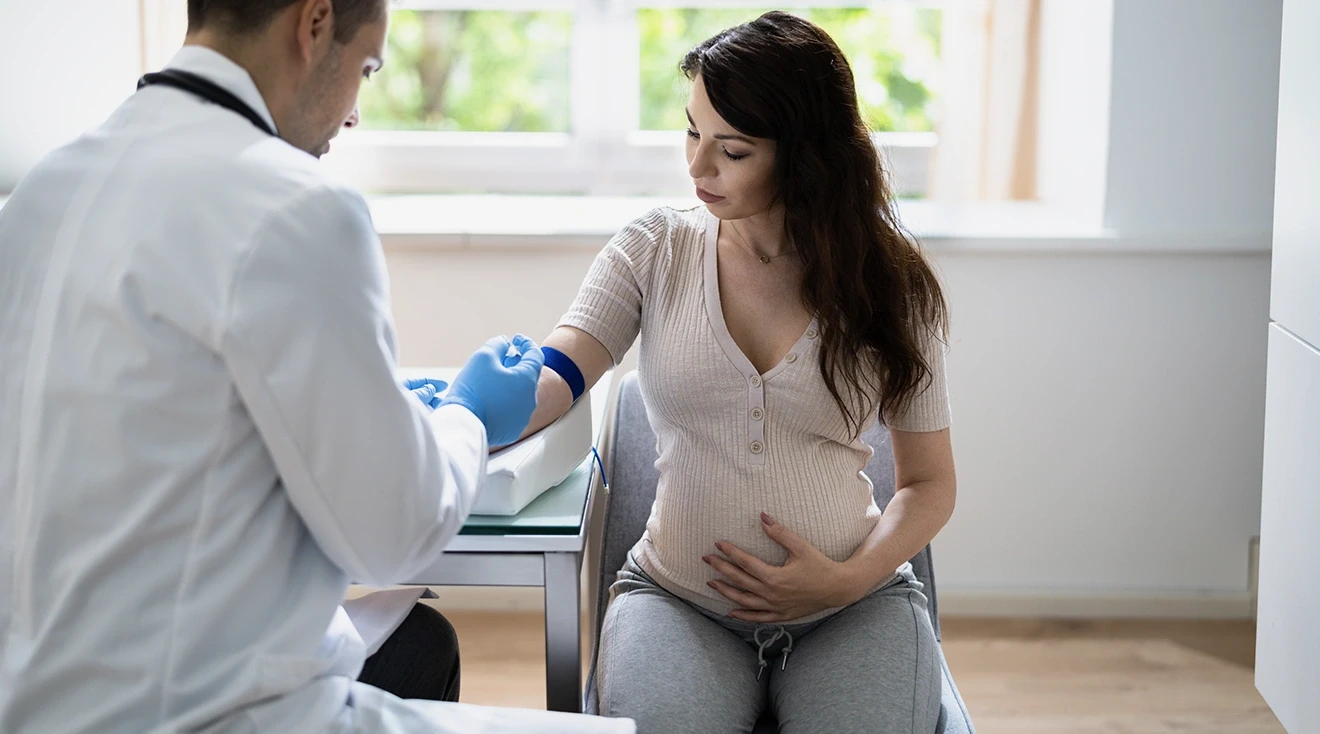 doctor doing a blood test for pregnant woman