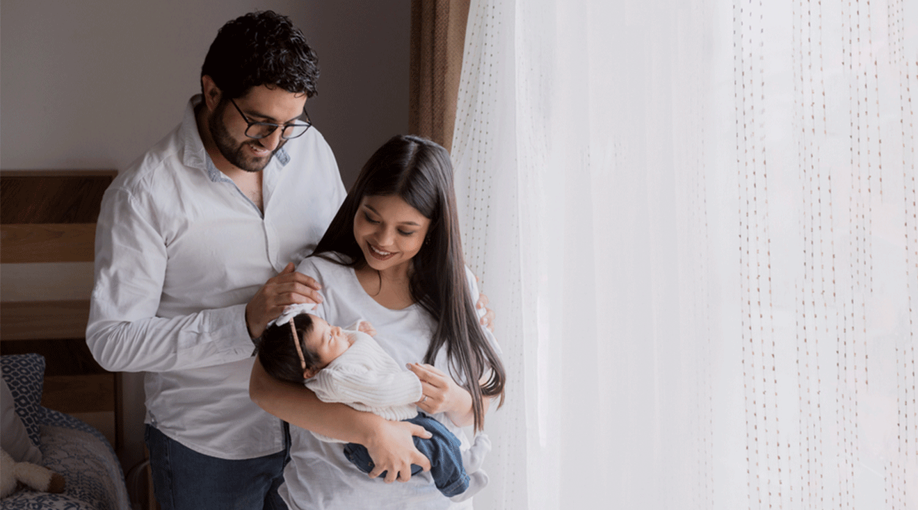 mom and dad at home with their newborn baby