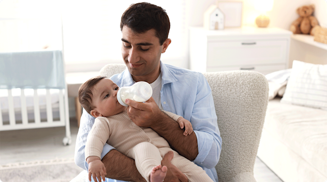 dad giving baby a bottle