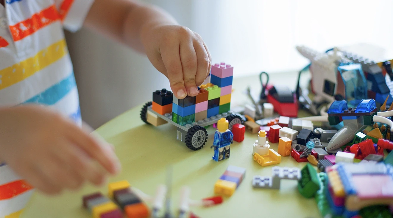 close up of child playing with legos