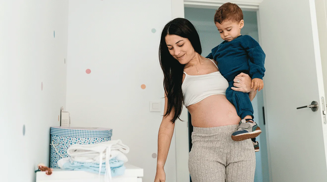 pregnant mom holding toddler
