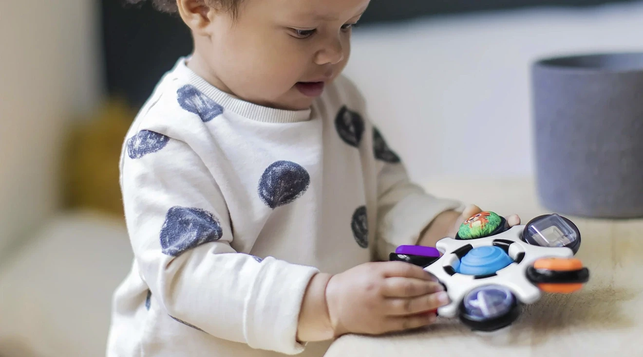 baby playing with baby einstein sensory toy