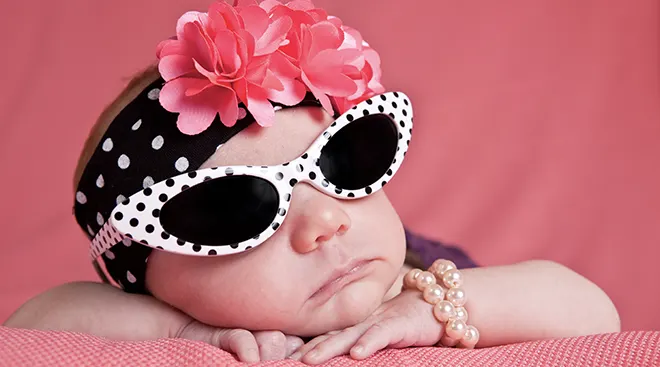 baby girl dressed up with sunglasses and headband