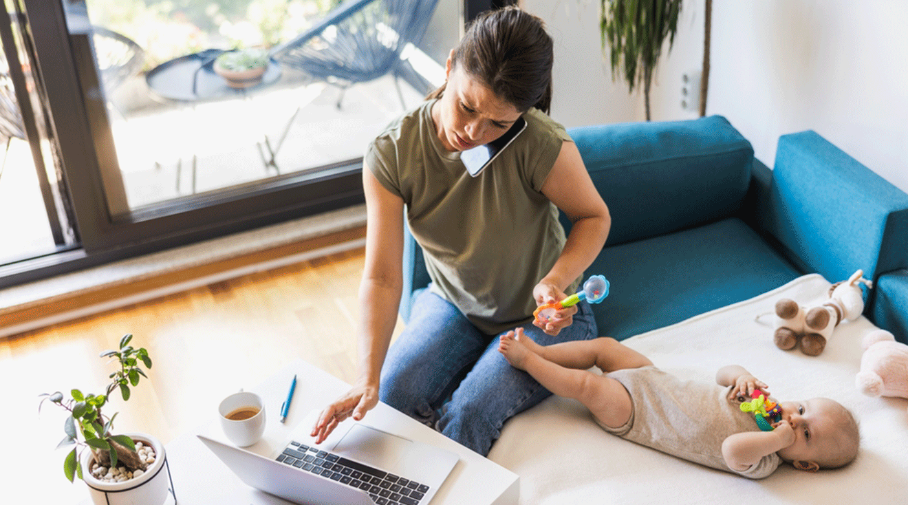 single mom talking on phone and working on laptop while at home with baby