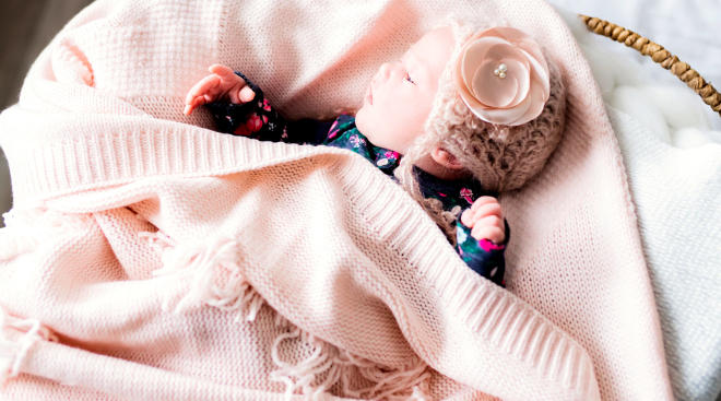 newborn baby wearing a pink knit hat