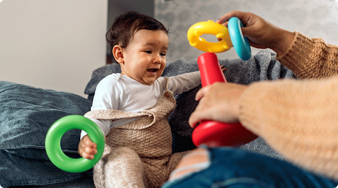 mom and baby playing with toys at home