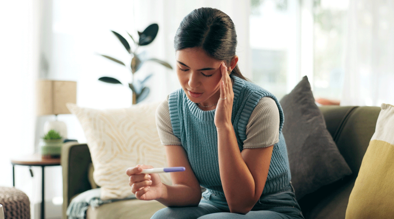 woman looking at pregnancy test