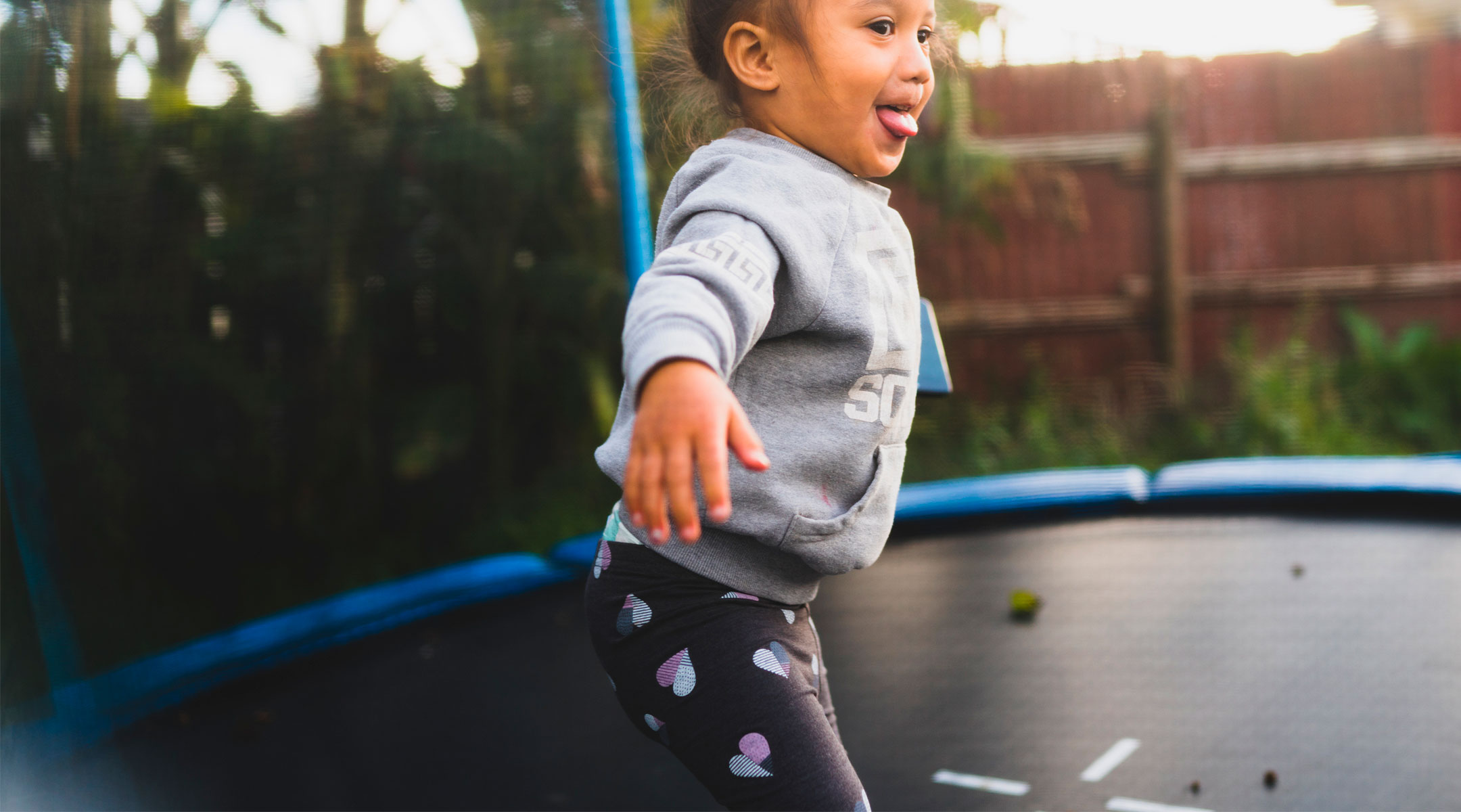 toddler jumping on trampoline