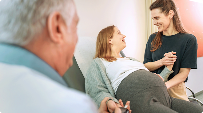 pregnant LGBTQ couple at the doctor's office.