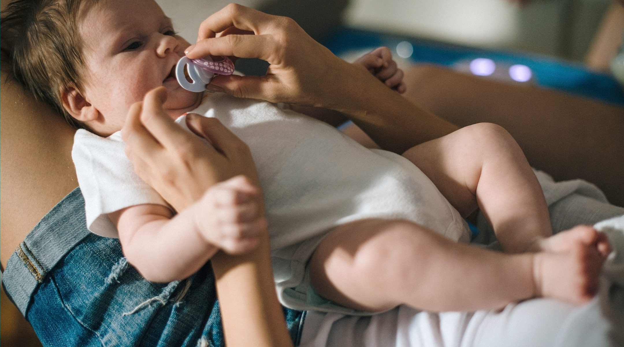 mom holding baby's pacifier