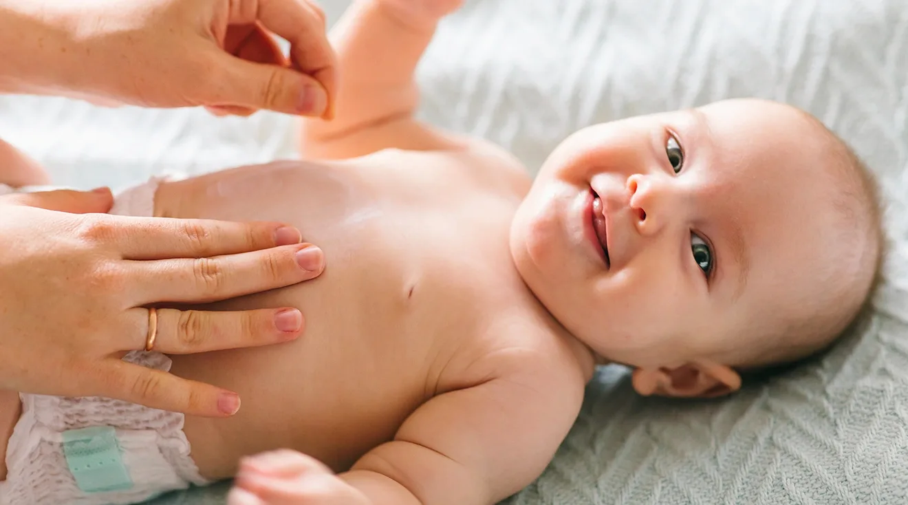 smiling 4 month old baby in diaper