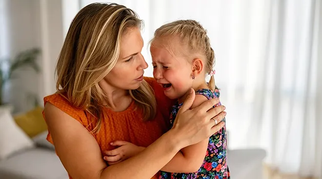 mother comforting crying child