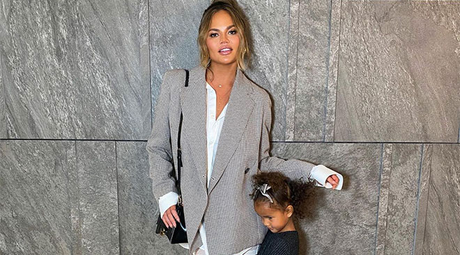 personality chrissy teigen pictured with her daughter hugging her legs