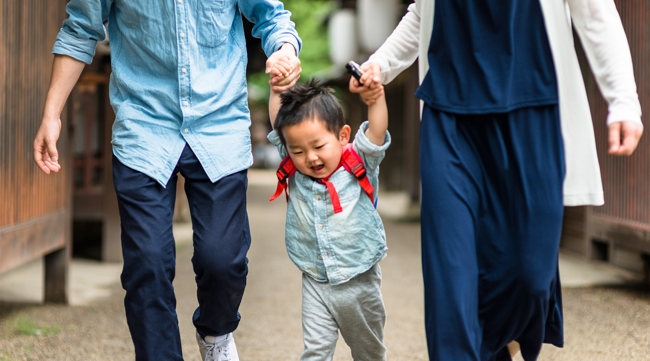 parent walking toddler boy to daycare