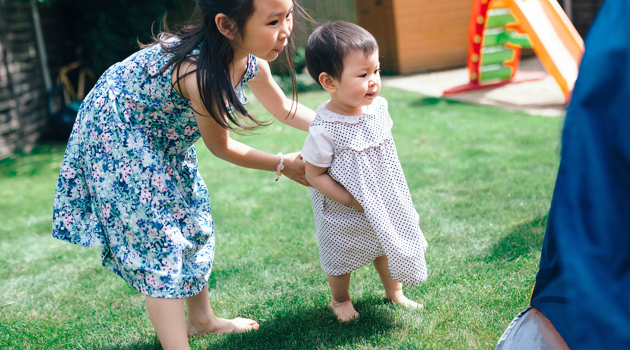 siblings playing outside in a backyard