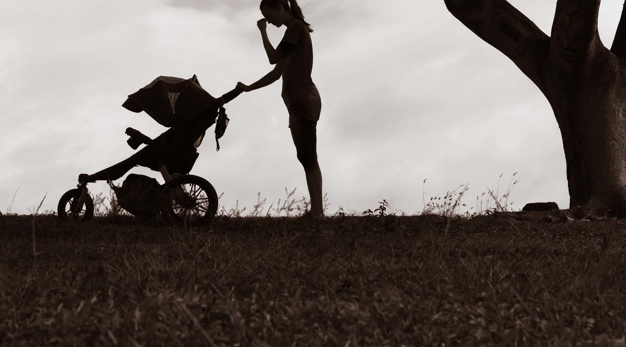 silhouette of mom with baby stroller outside