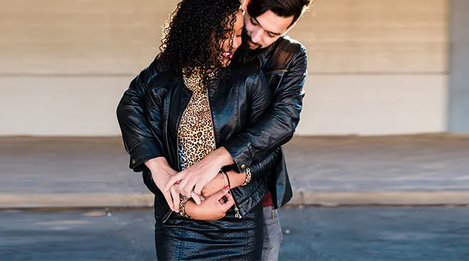 man hugging woman from behind