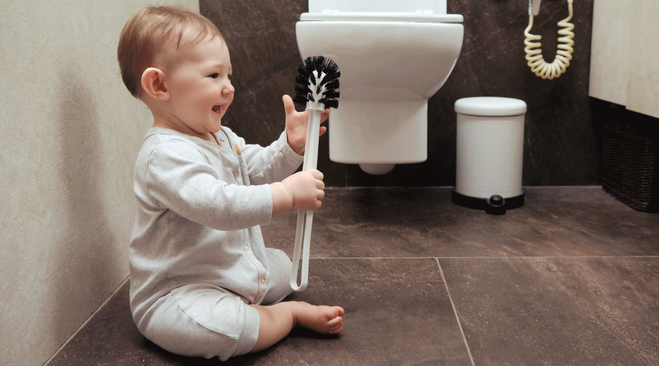 baby playing with toilet brush