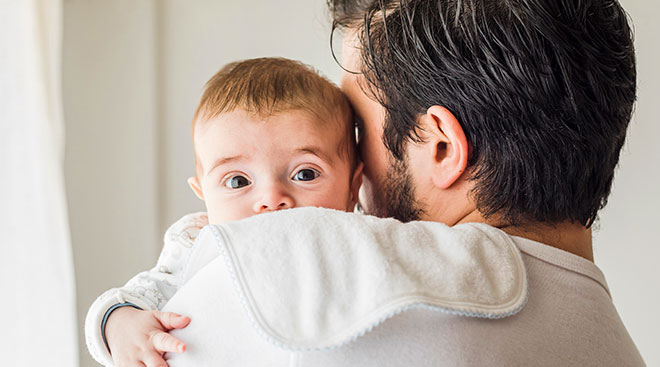 Dad comforting and holding baby. 