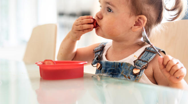 Toddler eating snack on the go