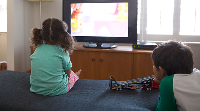 children in front of television 