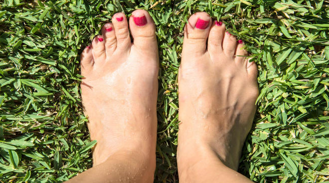 swollen feet standing on grass