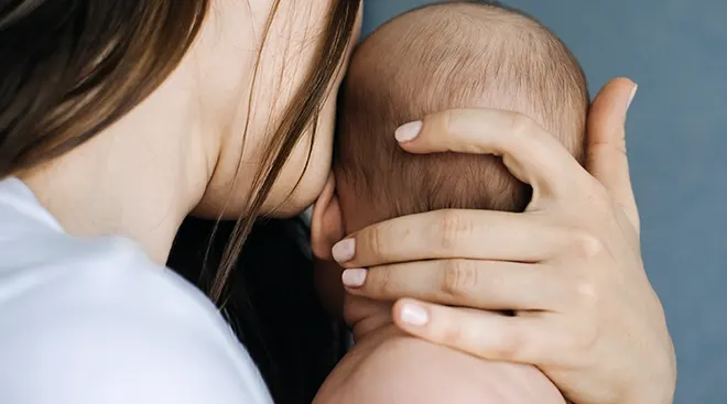 close up of mother holding baby