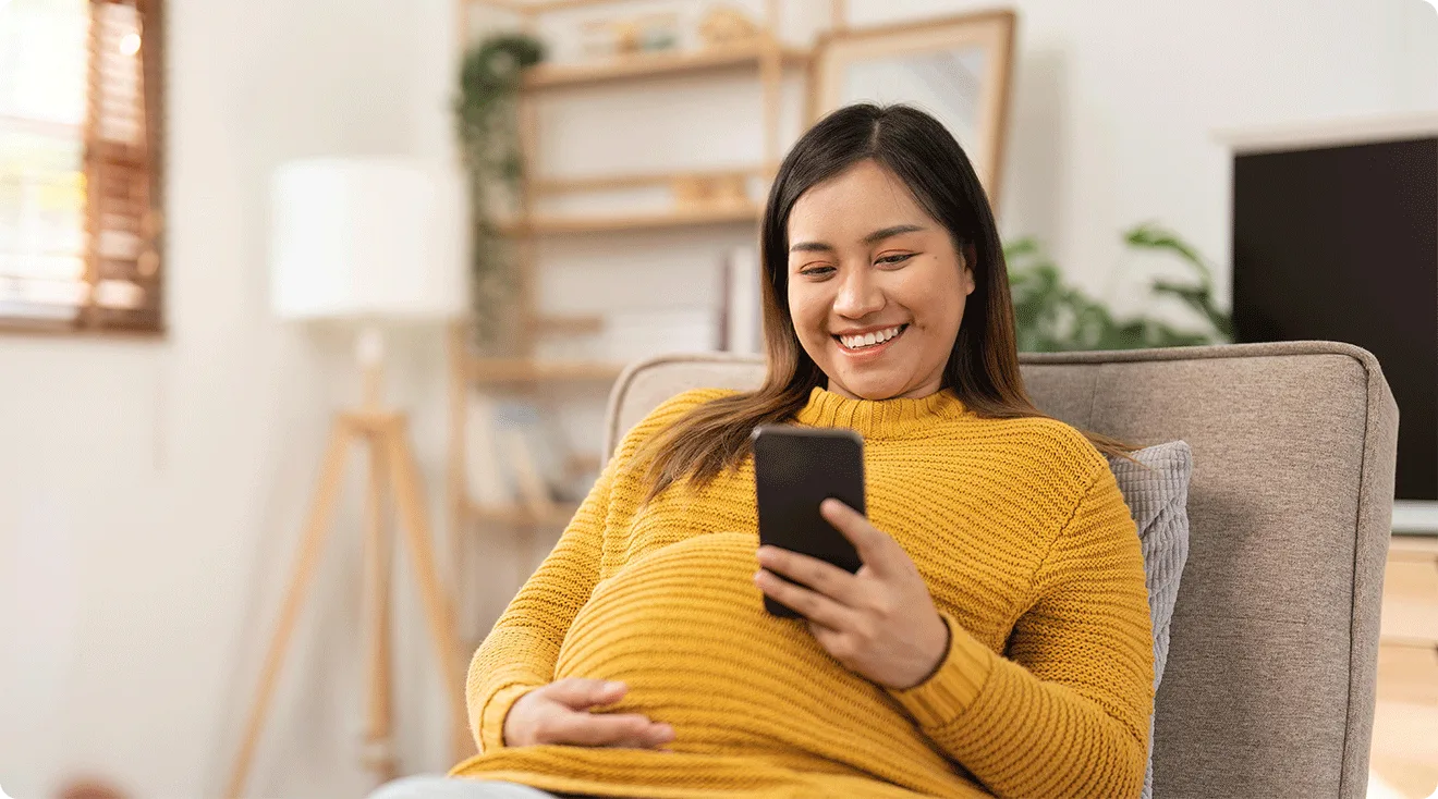pregnant woman using smartphone to play the bump baby name matcher game
